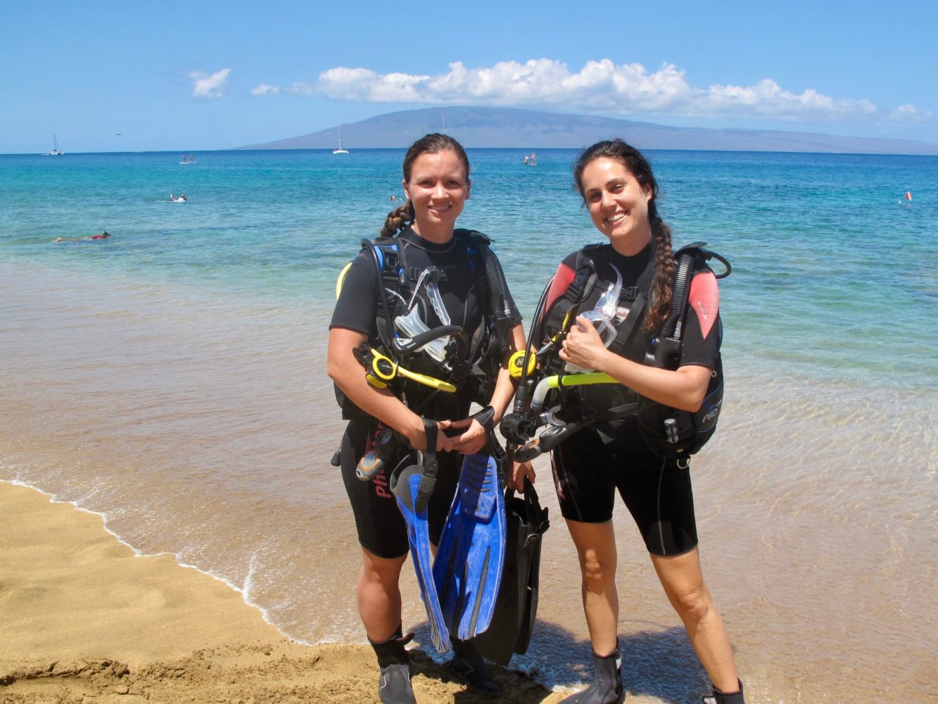Scuba divers in Maui are standing on the beach in Kaanapali.