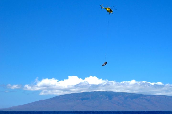 Maui emergency first response helicopter training with Lanai island in the background.