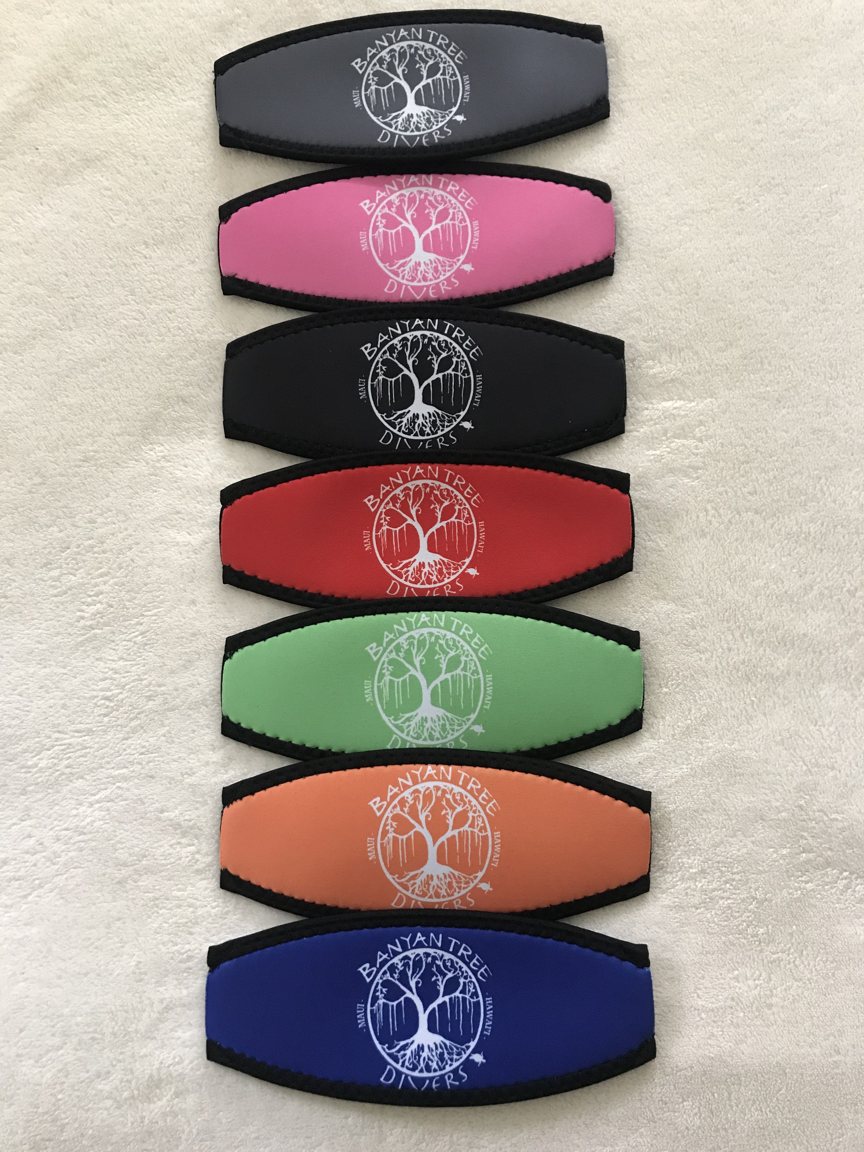 Scuba diving mask strap covers with the Banyan Tree Divers Maui logo.