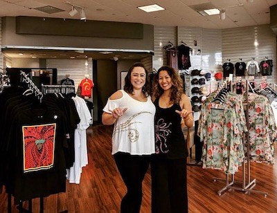 Two women standing inside a Nā Koa Brand clothing store in Maui.